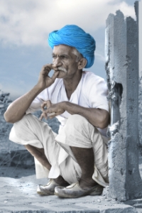 Indian man smoking a cigarette and wearing a blue turban